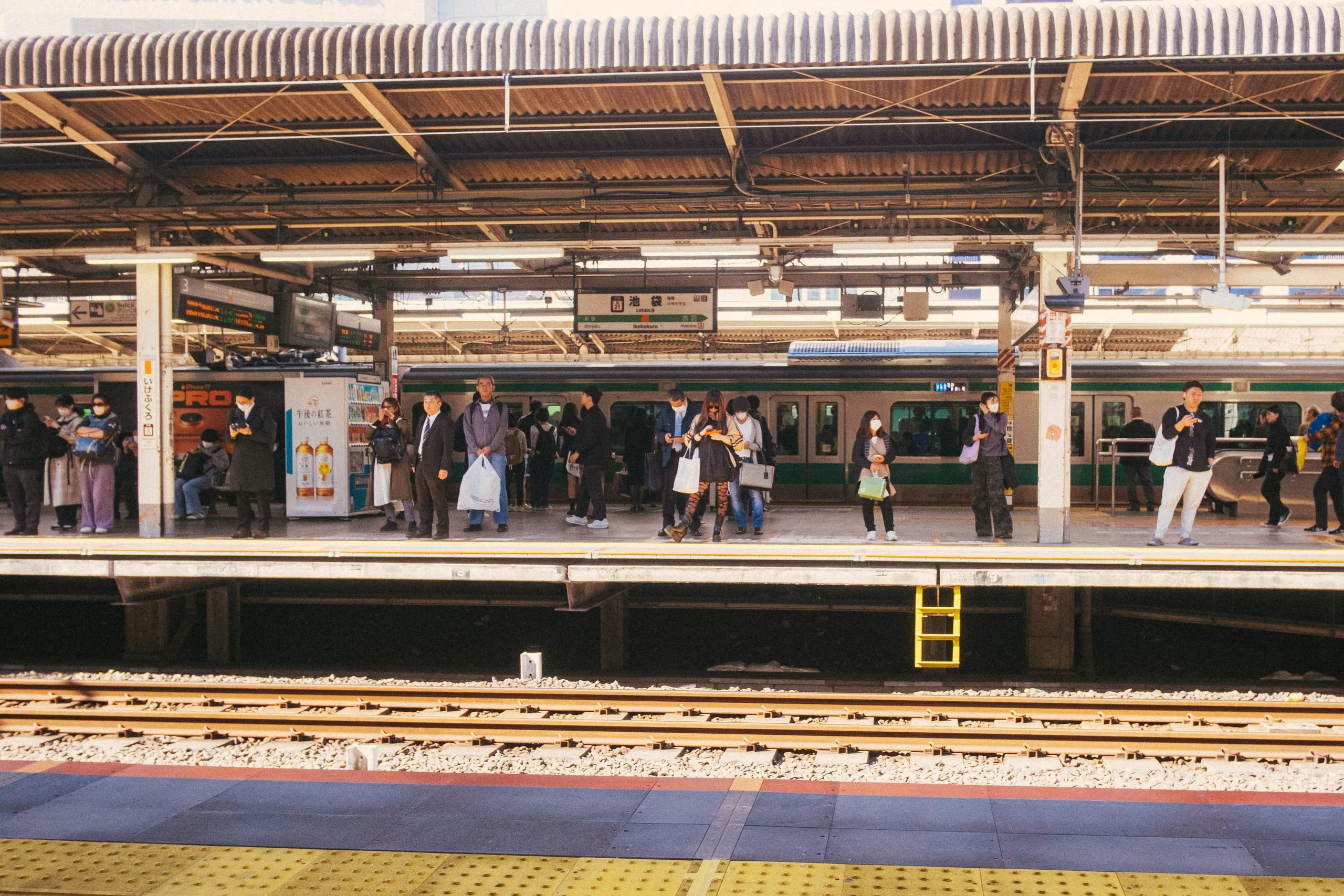 Commuters wait on the railway platform of Ikekuburo station