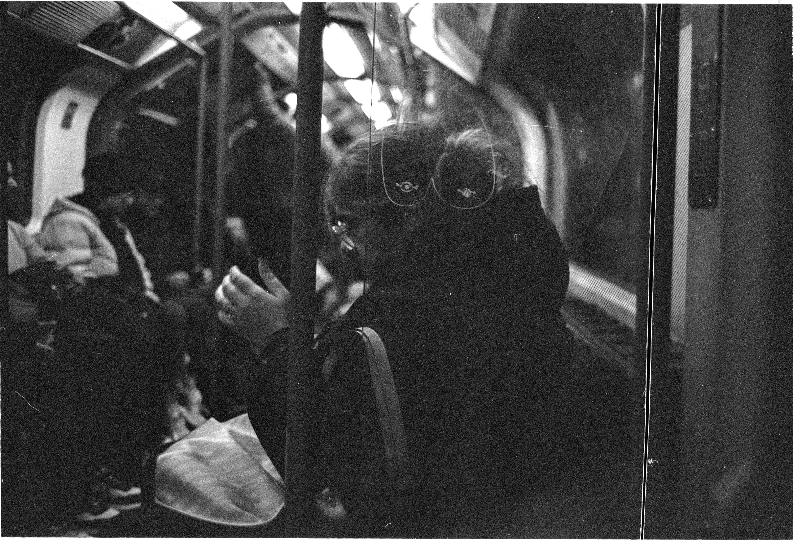 A woman checks her phone on the Underground