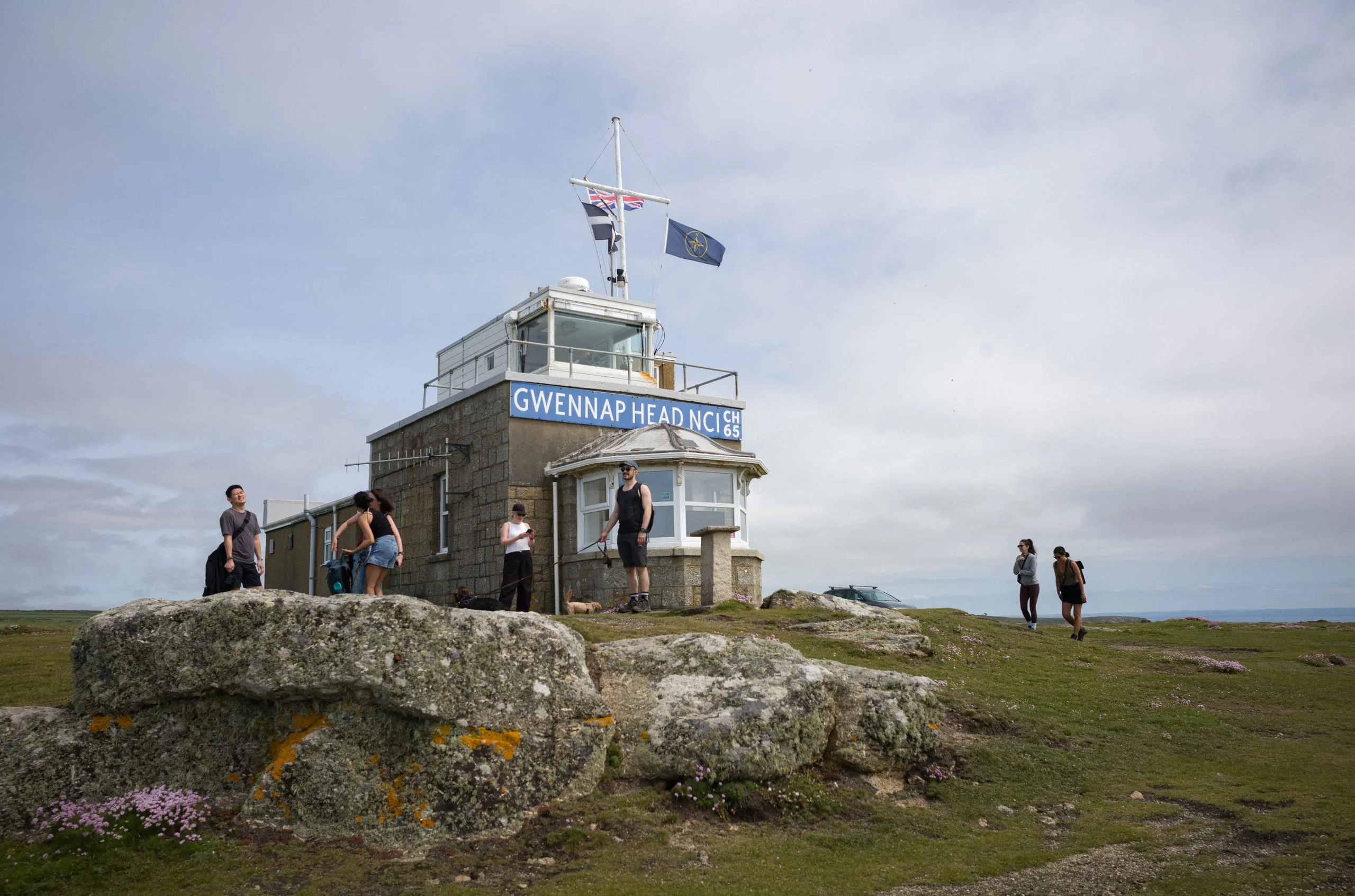 A group takes a break during a hike at Gwennap Head NCI coast watchtower