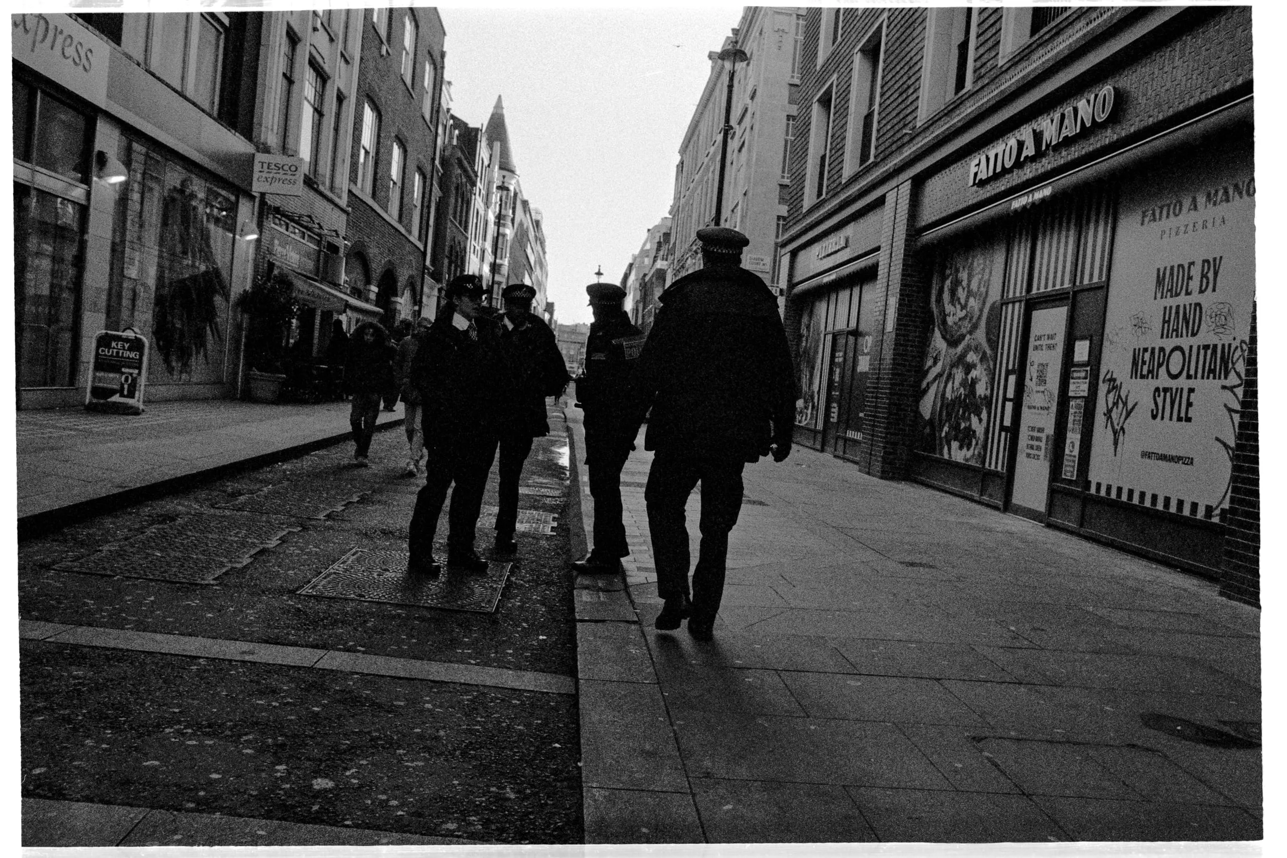 Police officers and pedestrians on Dean Street
