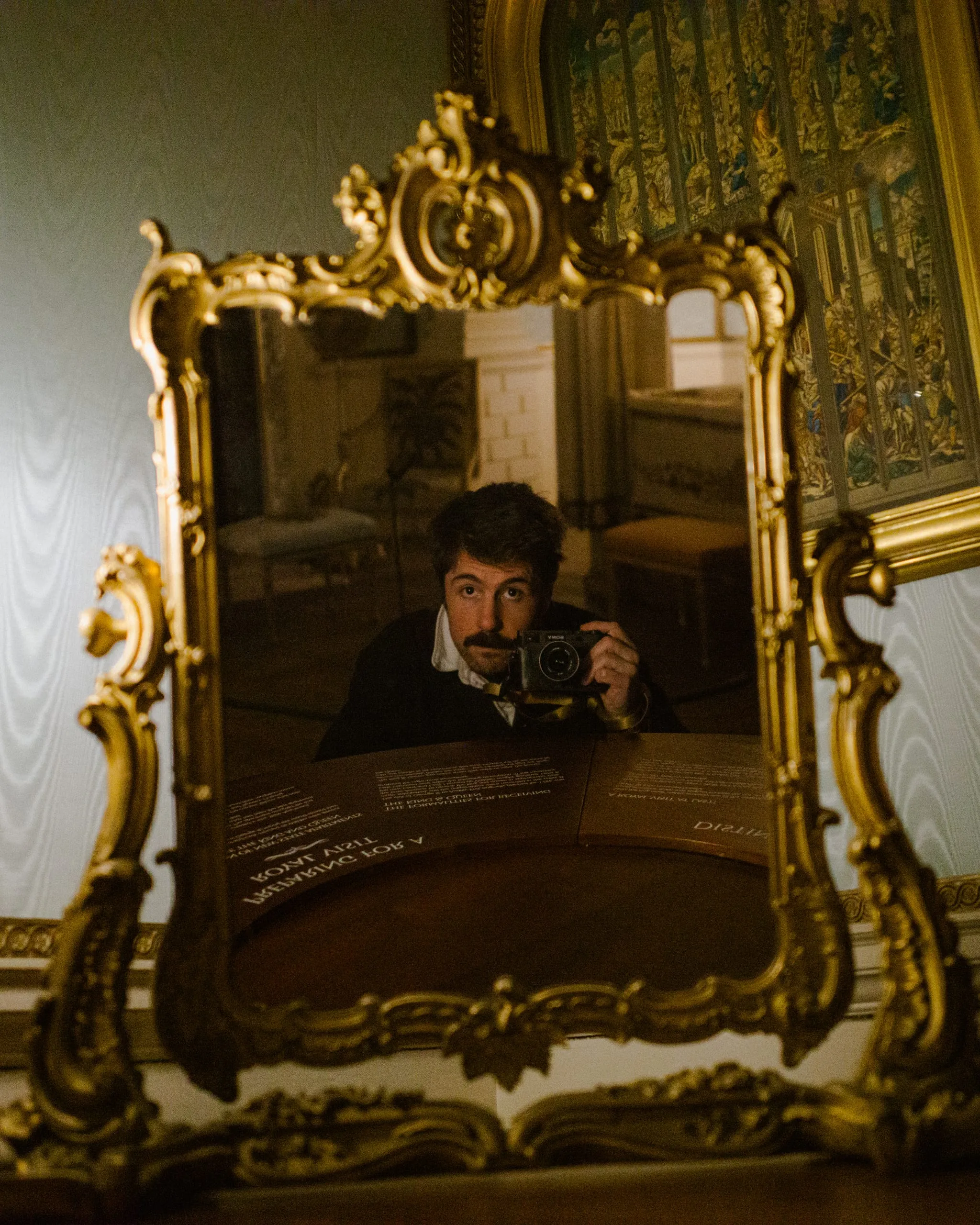 Self-portrait on ornate gilt mirror