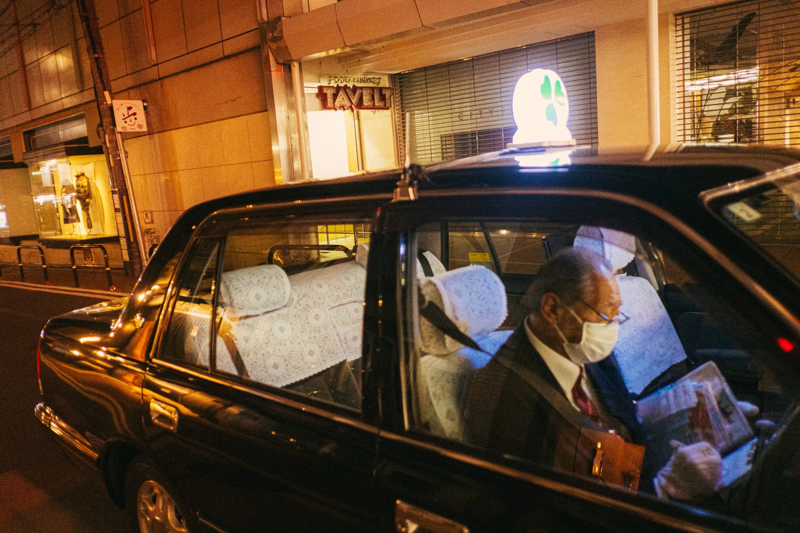 A Yasaka Taxi Group driver updates paperwork while waiting for his next ride