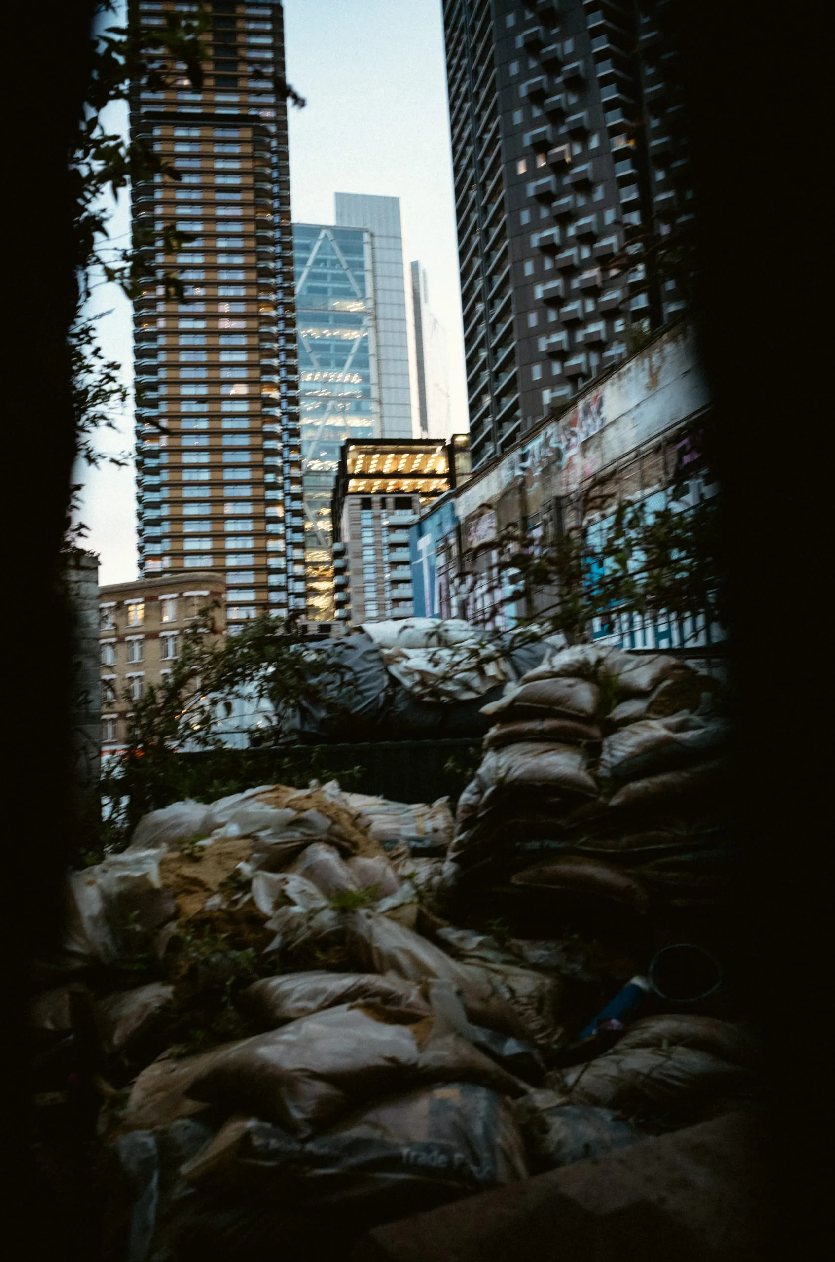 Bin bags piled on a rooftop with City of London skyscrapers behind