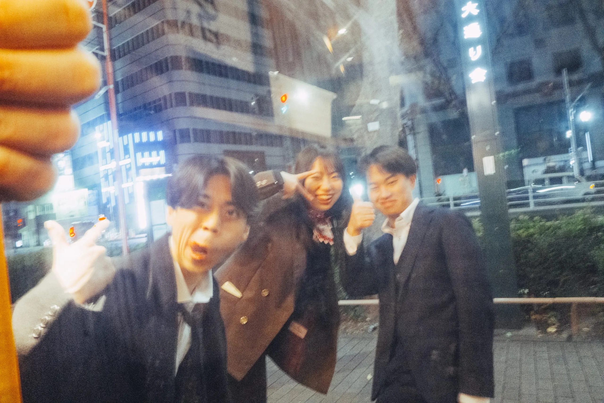 Youths posing for a photo taken from a late-night ramen bar, Shinjuku ni-chome