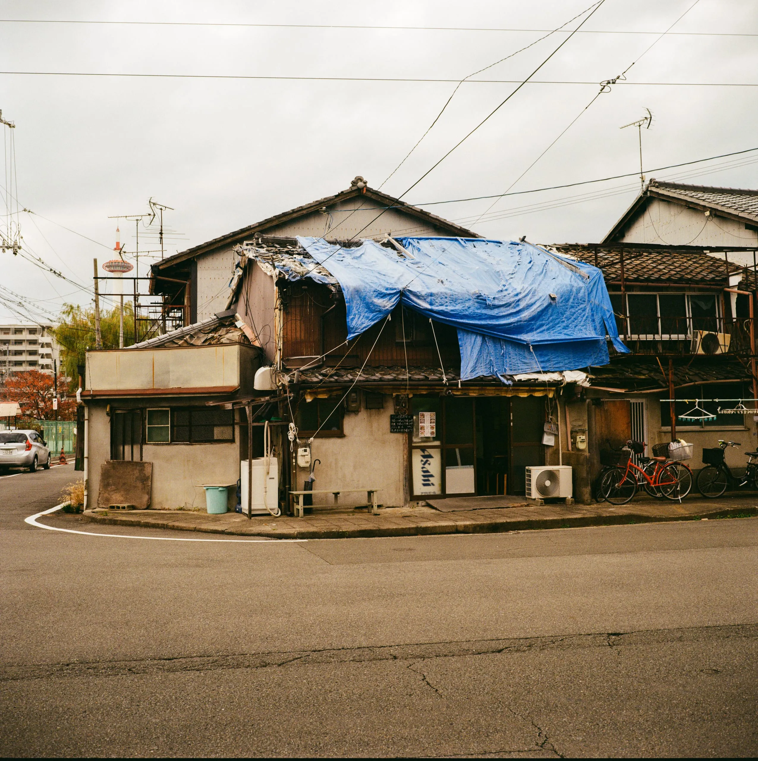 An old tarp-covered restaurant on a quiet street corner