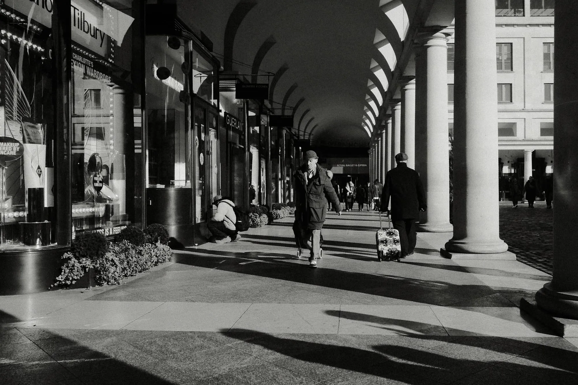 Two men pull luggage in different directions, Covent Garden