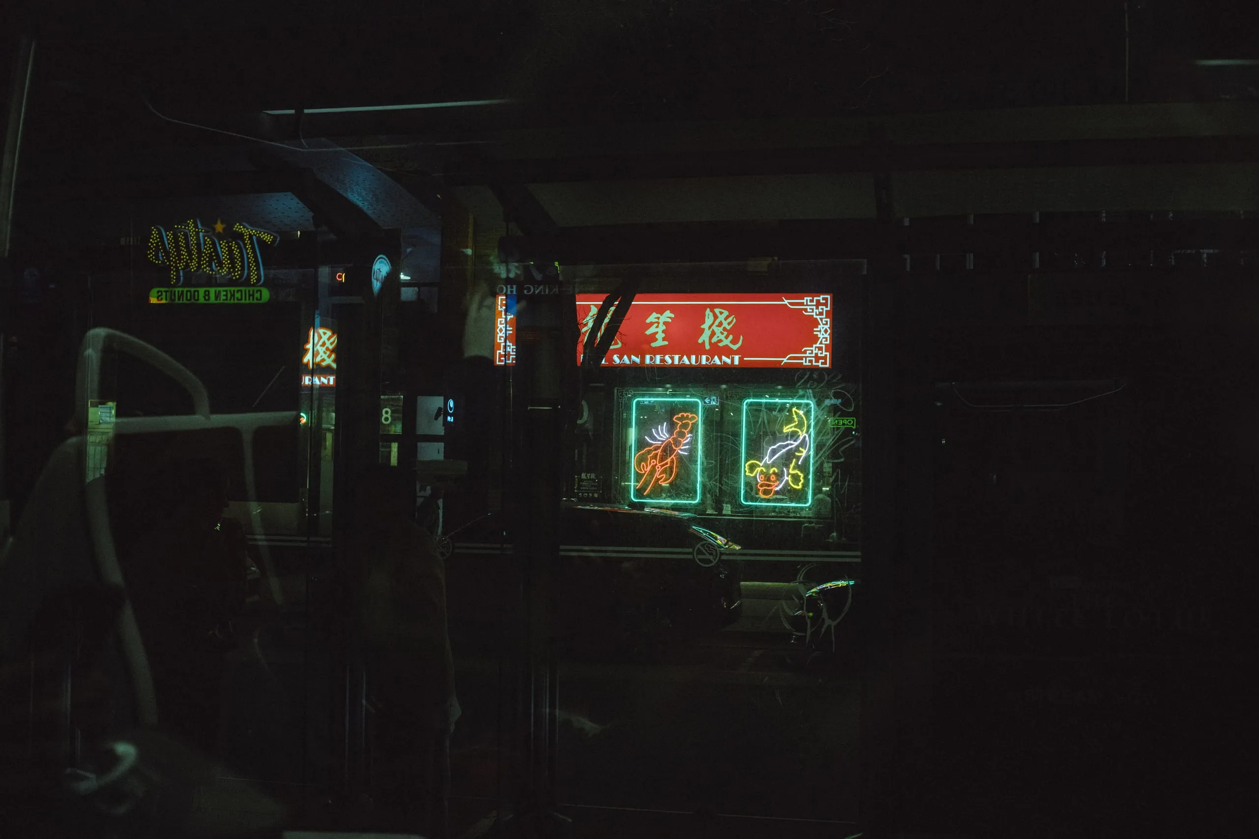 Lobster and Koi fish restaurant neon signs from the tram in Spadina ave