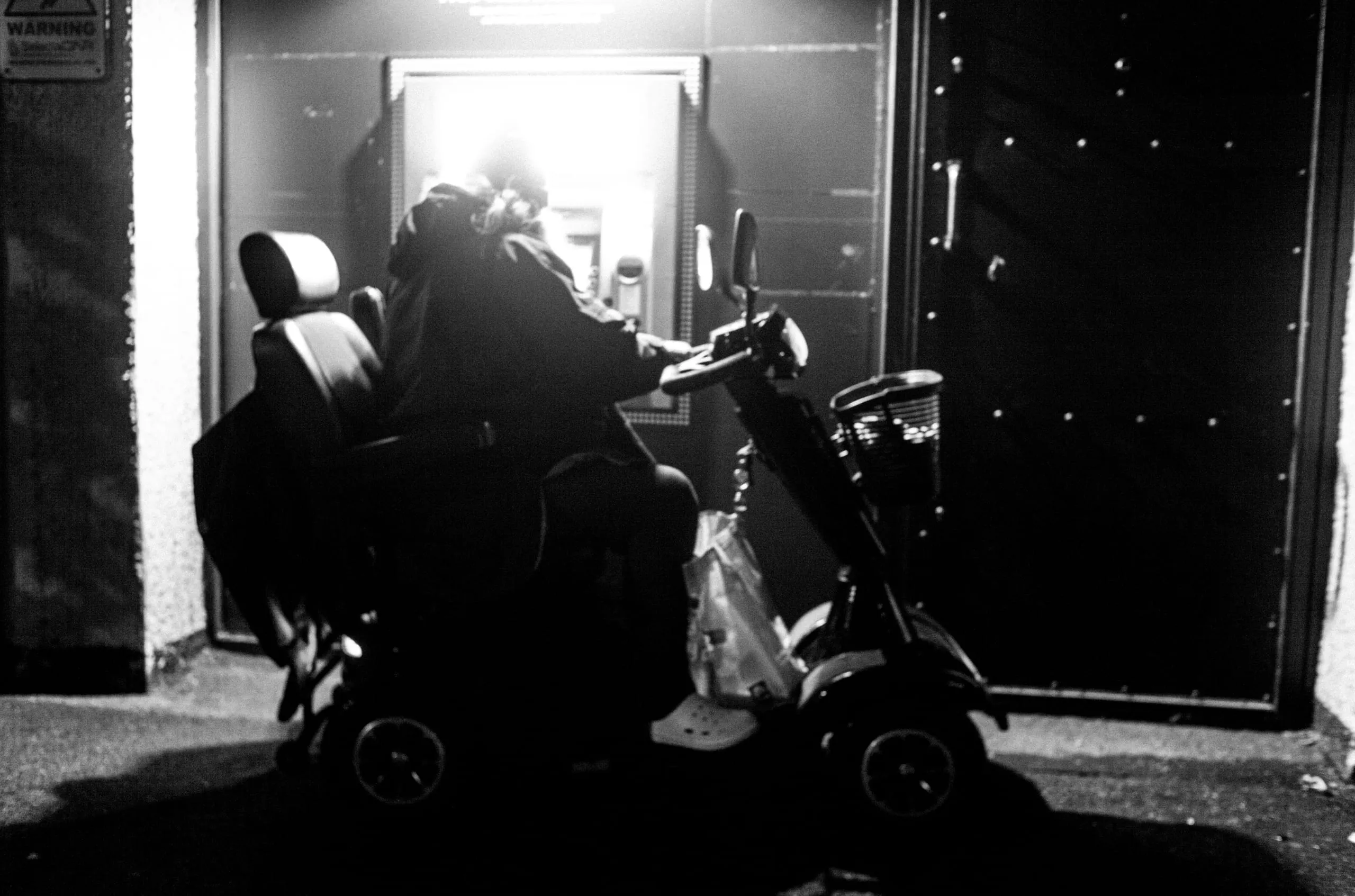 A man takes out cash late at night