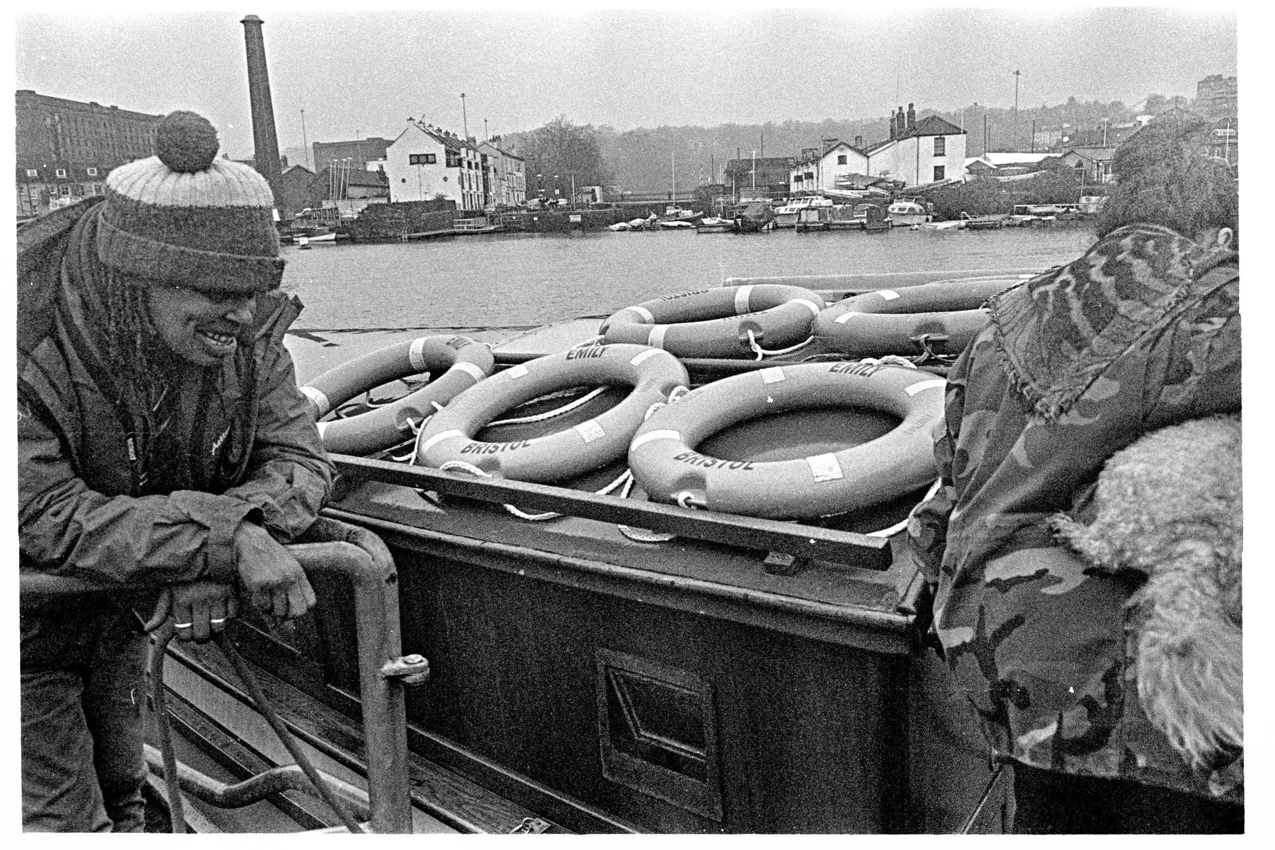 Ferry operator watches over as passengers board the river ferry