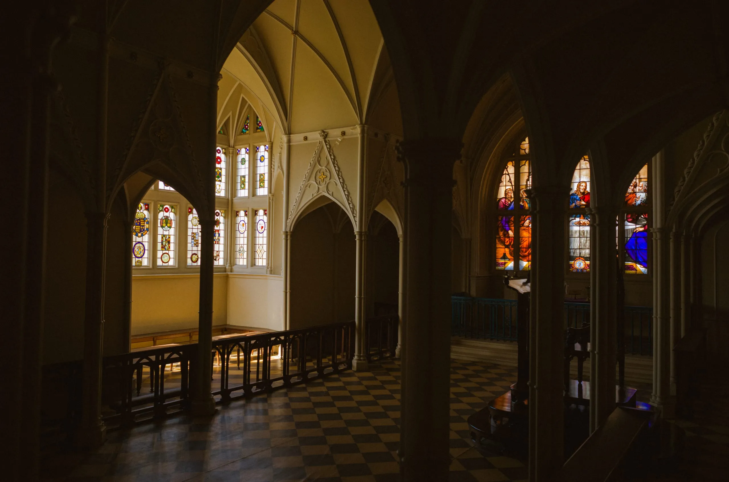 Stained glass windows and a tiled floor inside a  chapel