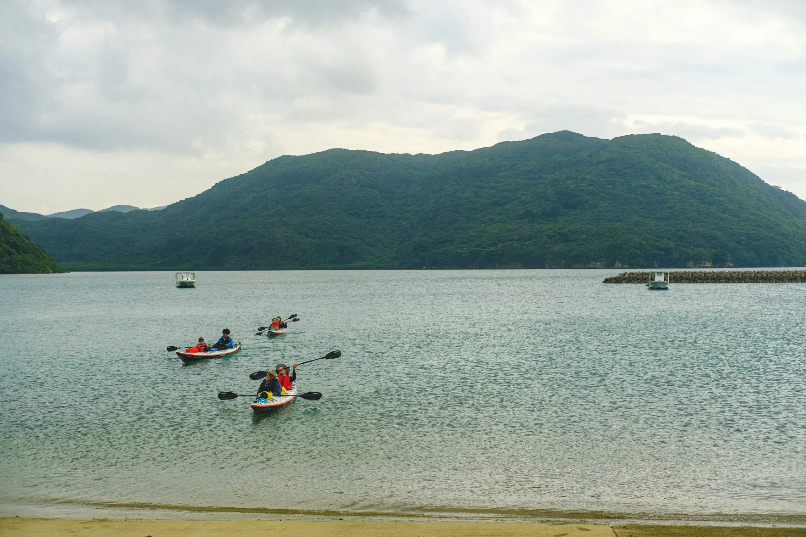 Kayakers from a hotel tour return to Shirahama port