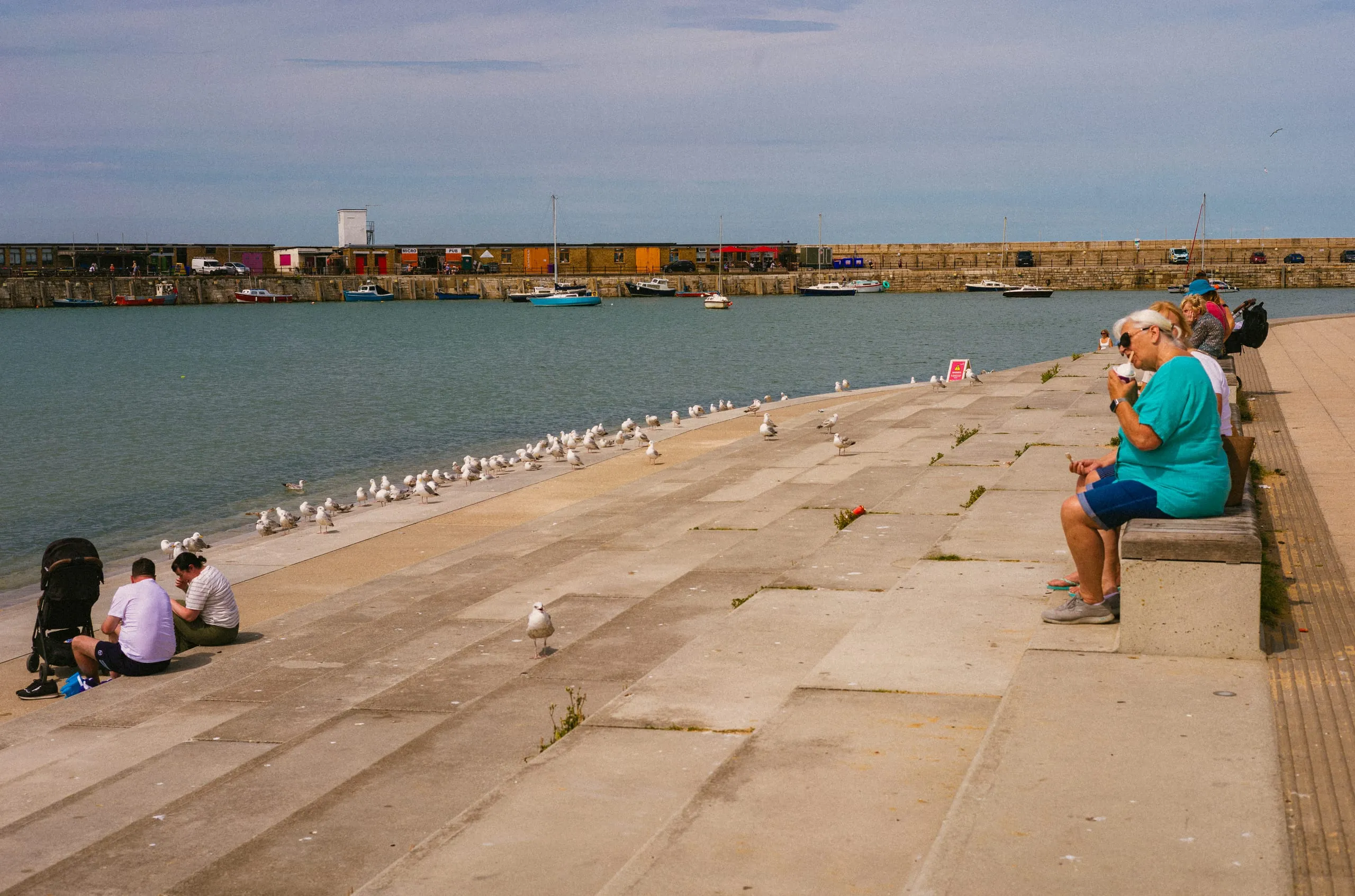 A woman enjoys ice-cream at the King's steps