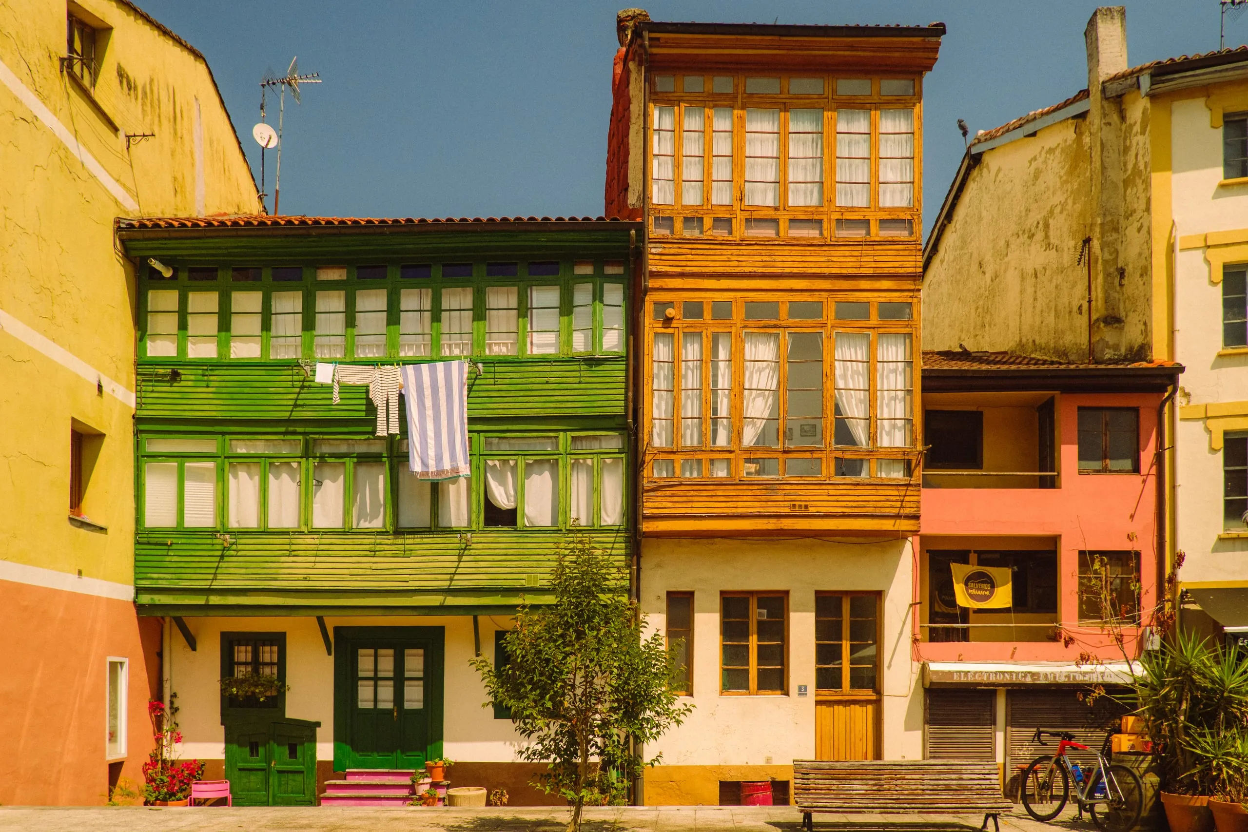 Colourful houses with enclosed wooden balconies and laundry hung out to dry