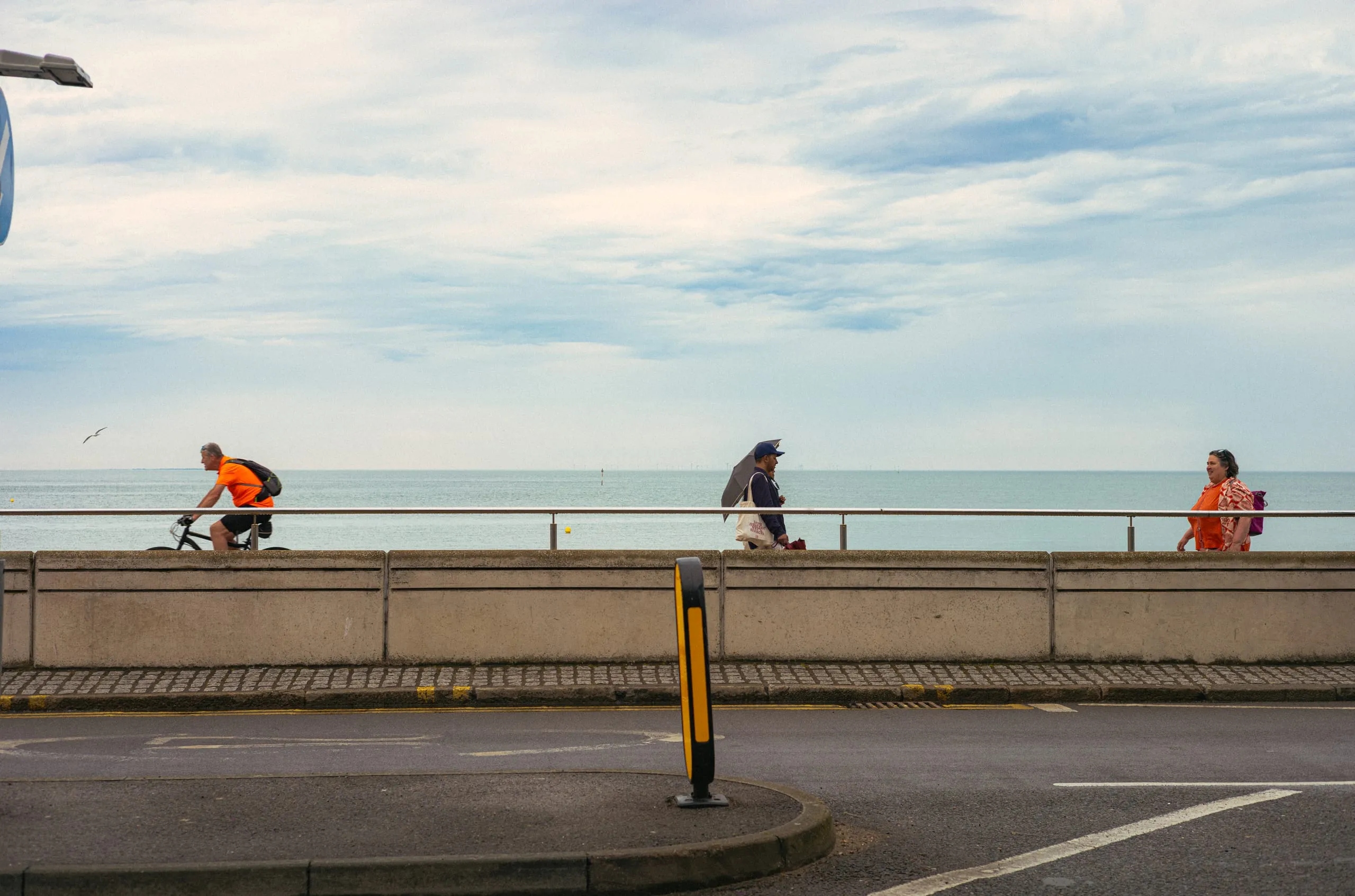 Passers-by pass by the seafront