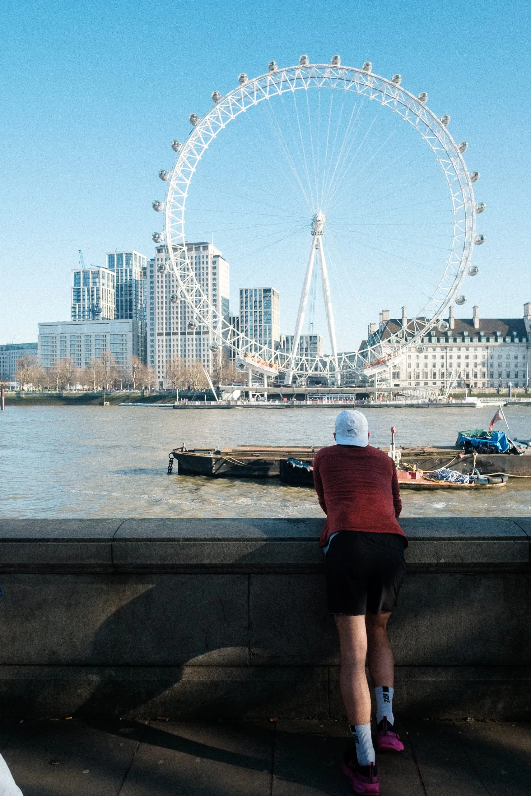 A runner financier glances over the Thames upon London Eye, The Strand