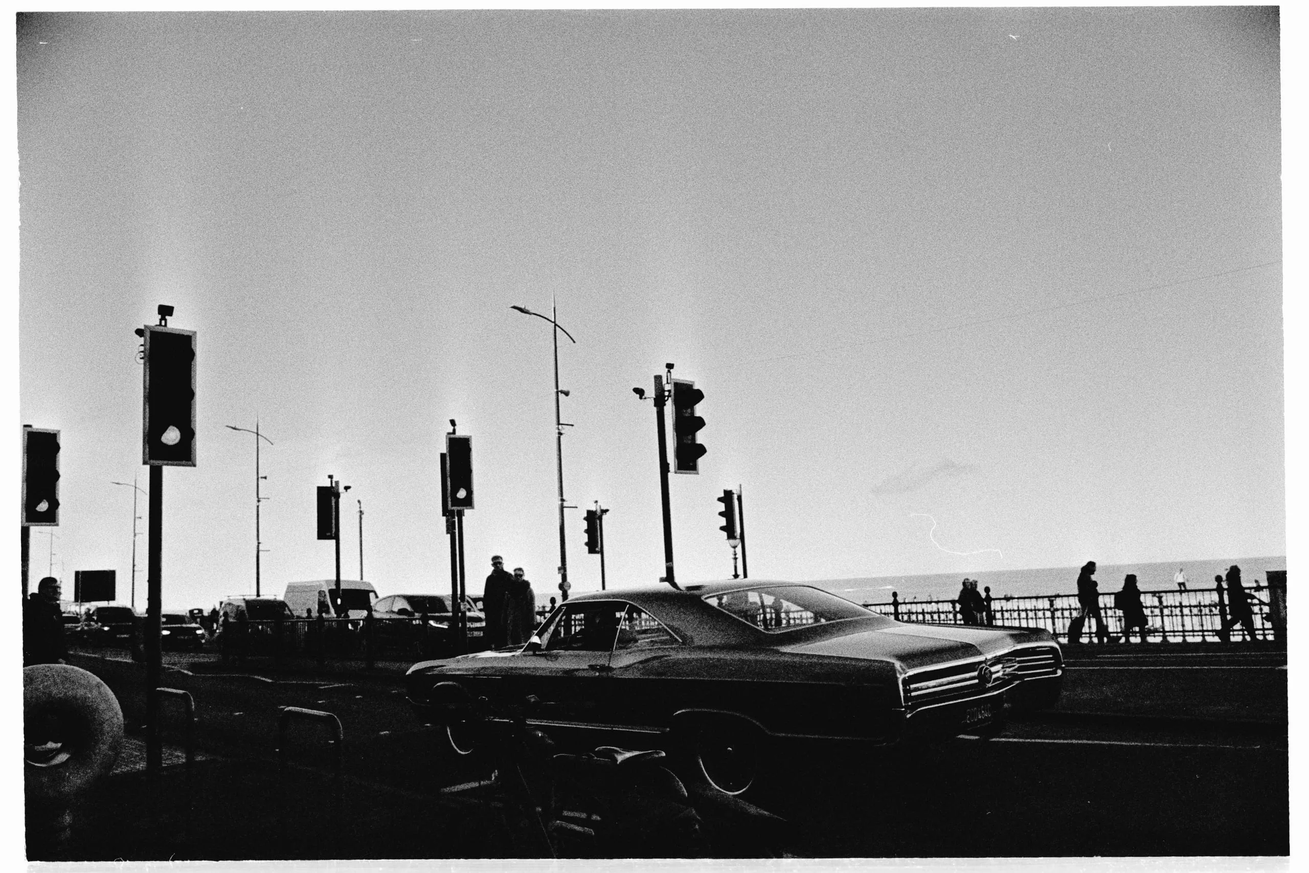 A car waits at traffic lights on a seafront road, Margate