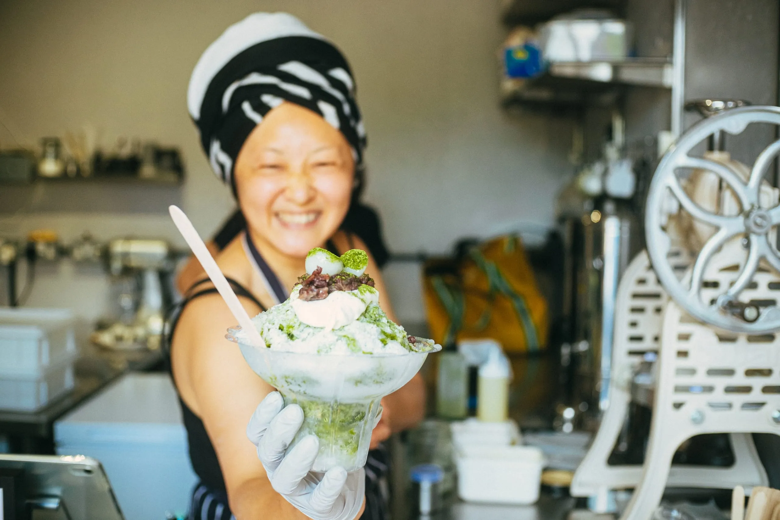 A woman serves a matcha dessert, Hackney Wick