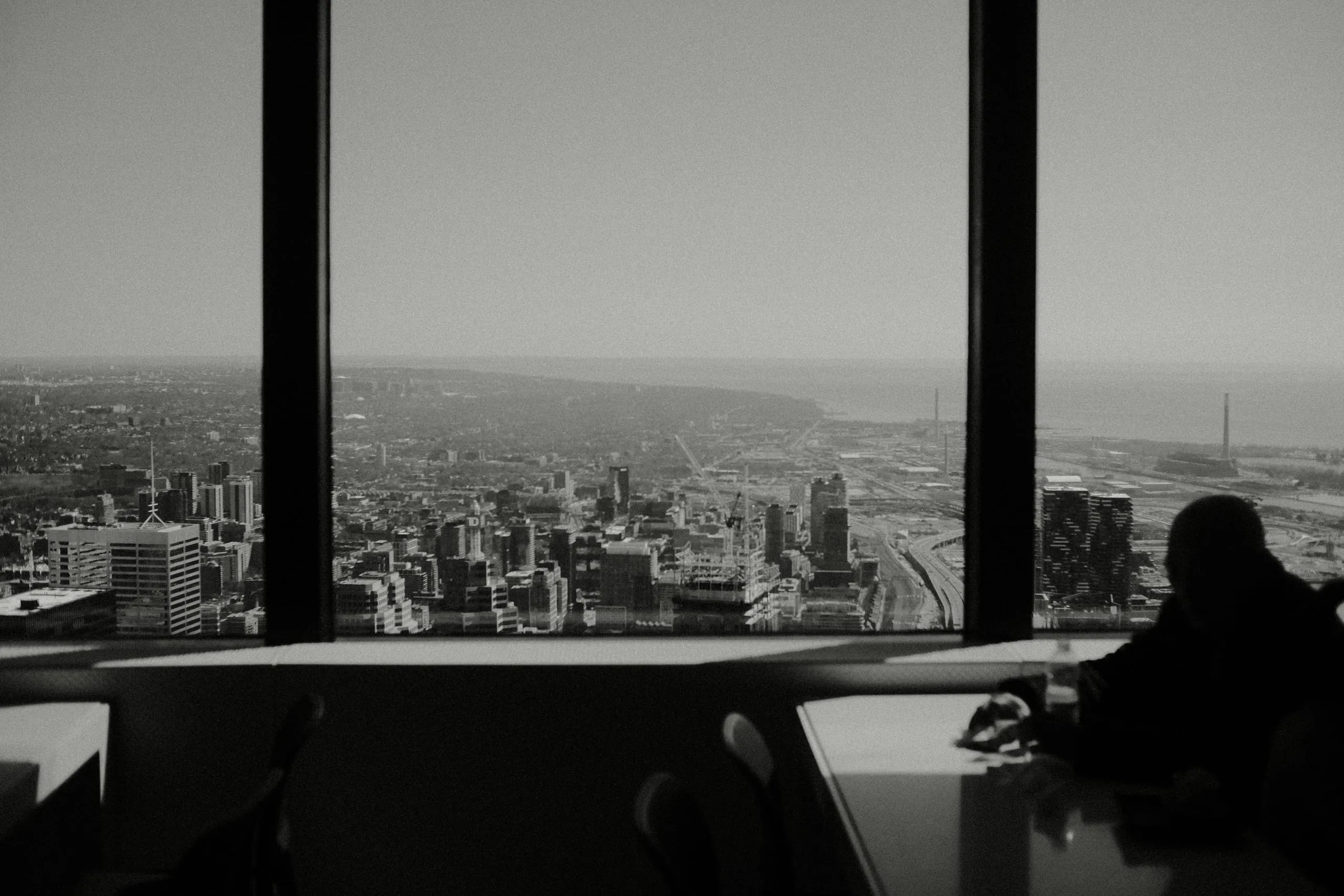 A man enjoys a drink of water at the CN Tower observation deck
