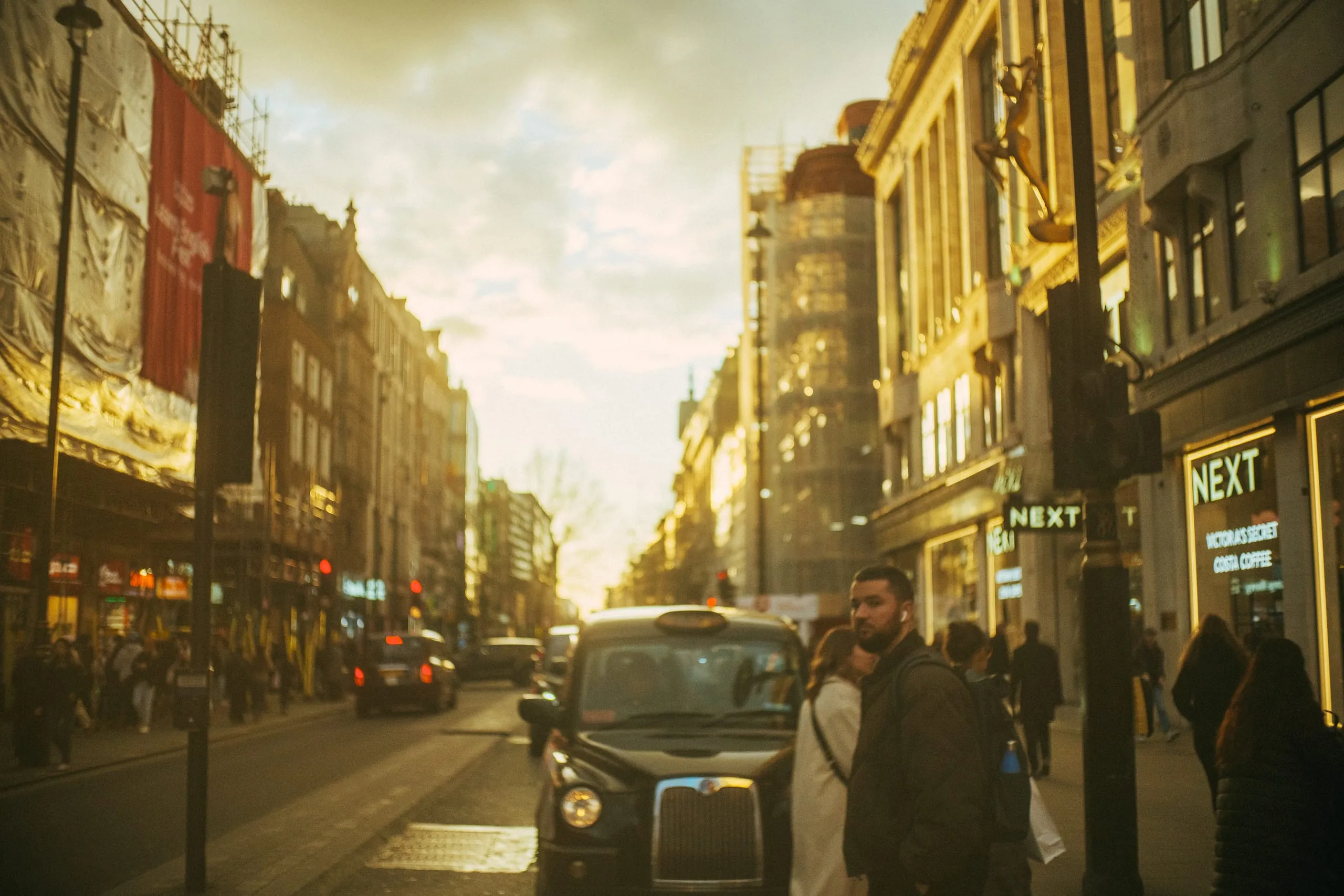 A man crosses Oxford Street at Sunset, Soho
