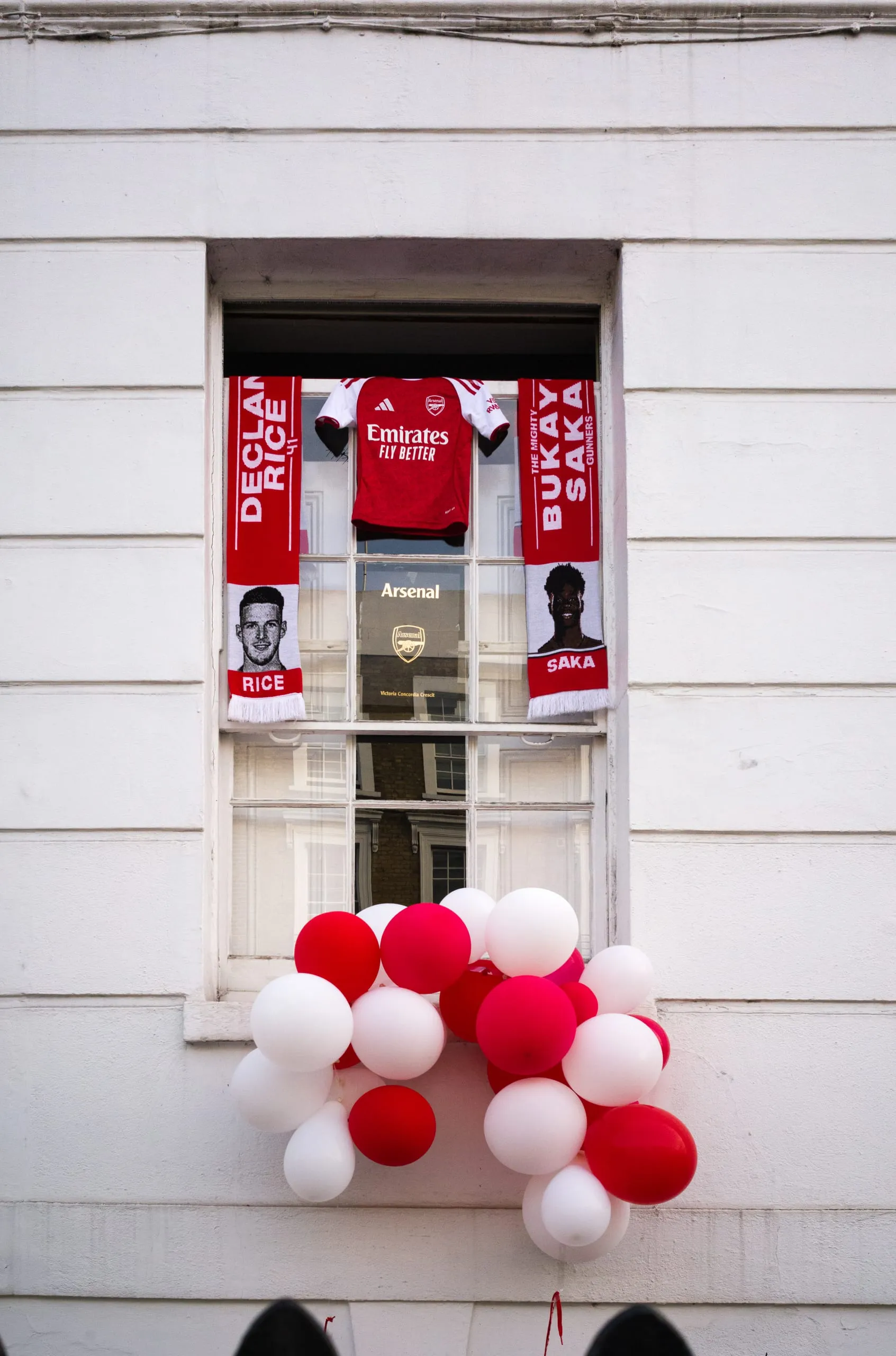 Arsenal gear hangs by a window to commemorate their first Premier League victory in 20 years