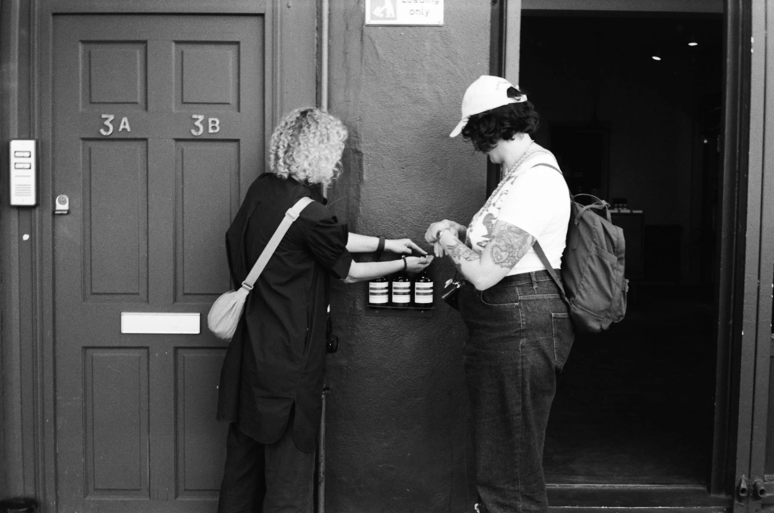 Debbie and Helena make use of the free Aesop dispensers at Broadway Market, Hackney