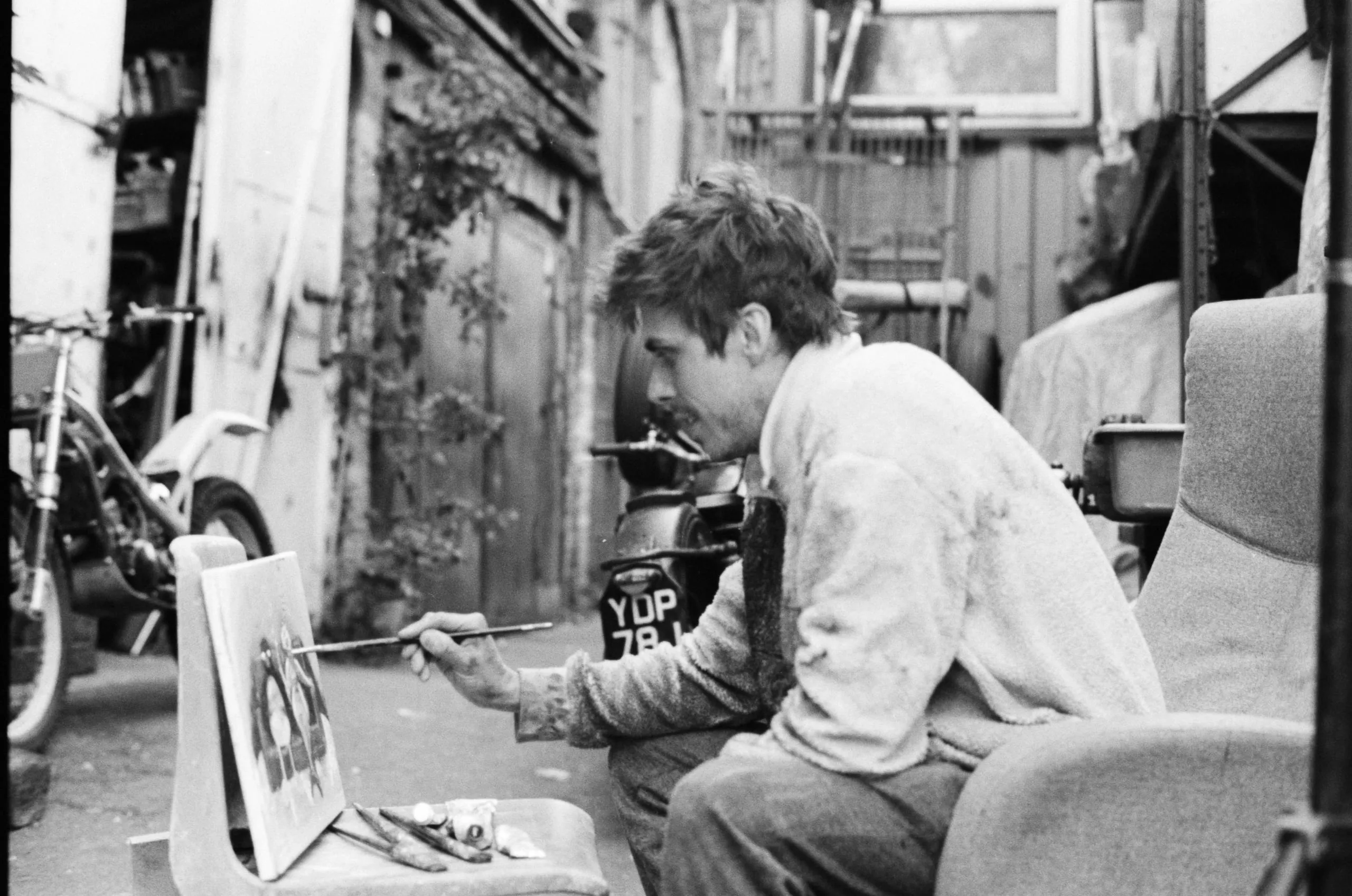 An artist poses with his work, Hackney