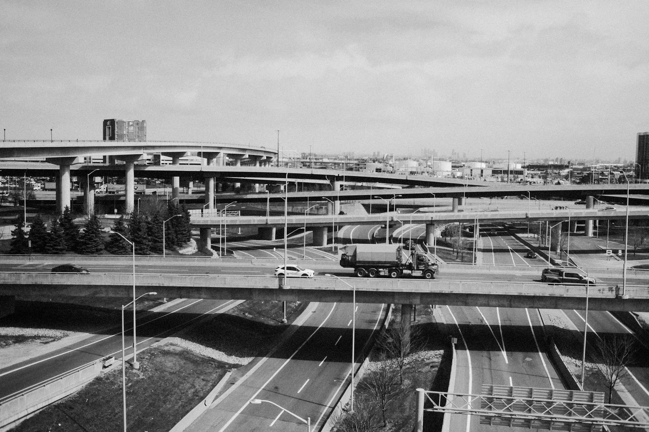 A truck drives over a bridge as seen from the UP express